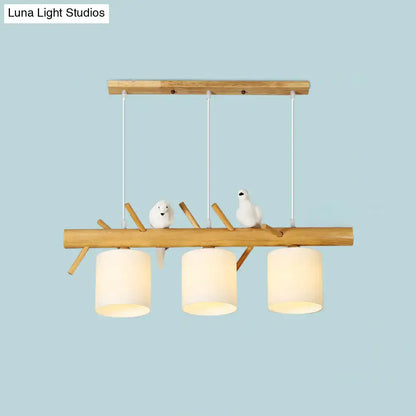 DecorBites modern branch island pendant light with three off-white glass shades and white bird figurines for dining room