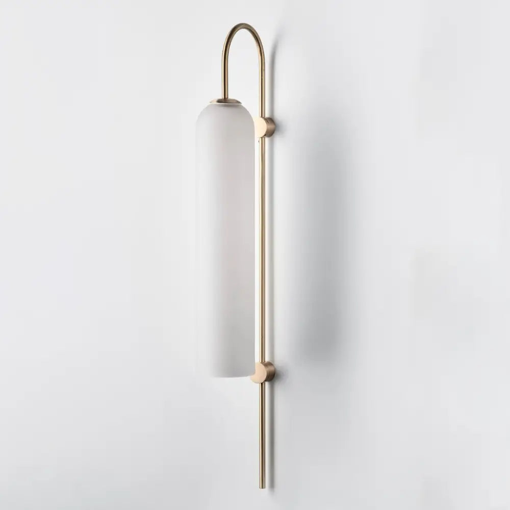 DecorBites™ modern brass wall sconce with a frosted white glass shade and slender brass wall frame ideal for pine green walls