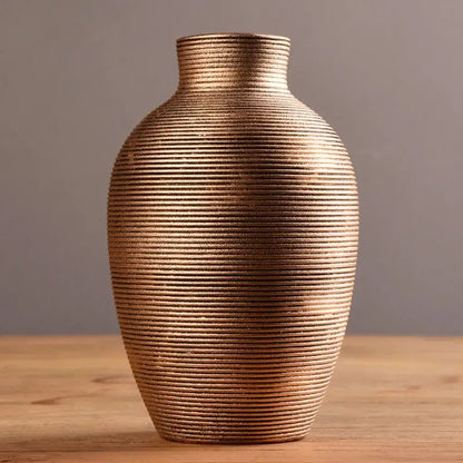 Bronze-colored ceramic nordic vase with textured ribbed surface and narrow neck for modern home decor by decorbites