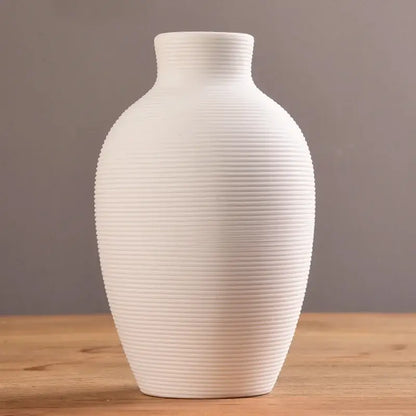 A sleek white decorbites™ modern ceramic nordic vase with subtle ribbed texture for elegant home decor
