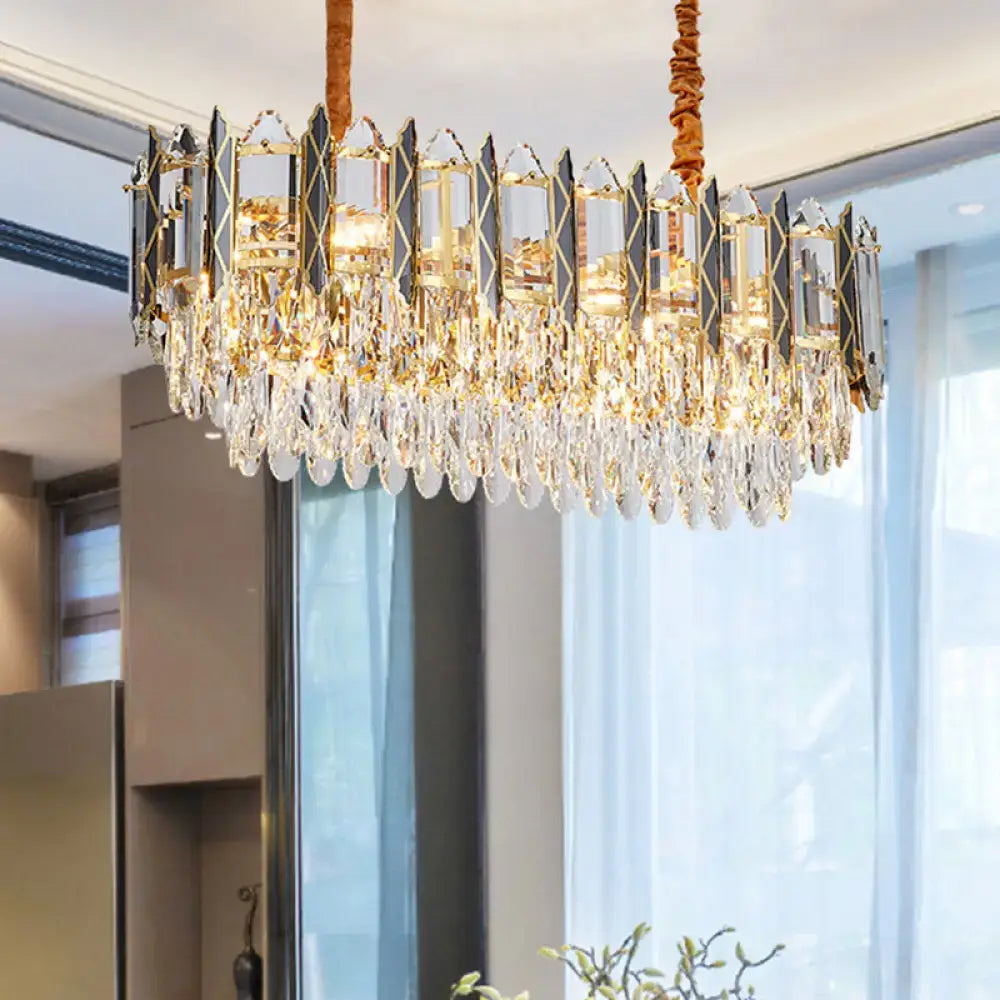 Elegant gold-toned decorbites™ crystal tiered oblong island light fixture with faceted crystal droplets and glass panels