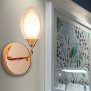 Modern gold wall lamp with frosted glass globe and curved metal arm for bedroom wall light fixture
