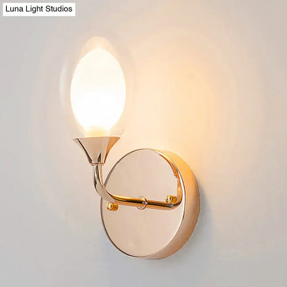 Modern gold wall lamp with sleek curved arm and oval frosted glass shade for stylish bedroom wall light fixture