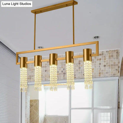 Decorbites modern gold-toned lighting fixture with crystal draping and five cylindrical pendants for island pendant use