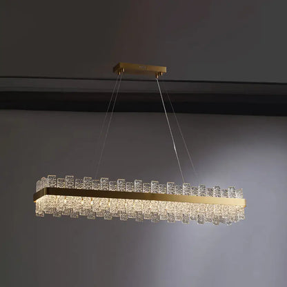 DecorBites™ modern crystal loop pendant light with brass plated frame and clear crystal cubes in a rectangular design