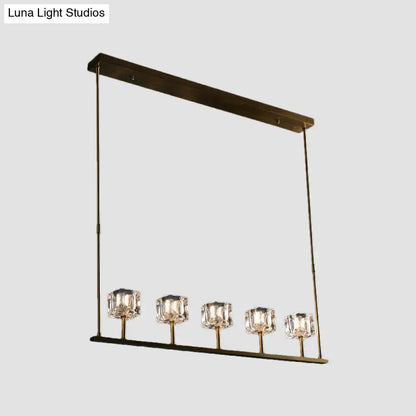 Modern brass-finished rectangular hanging island pendant light with five crystal glass shades for dining area fixture width