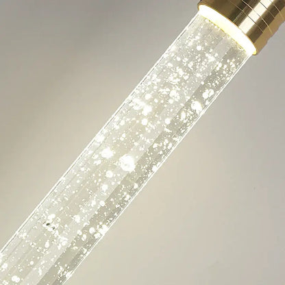 DecorBites modern crystal pendant light with clear glass tube, gold fixtures, and internal floating bubbles pendant light