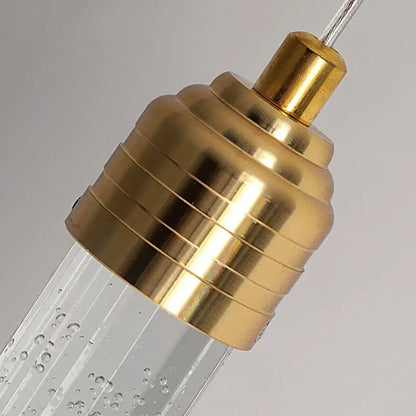 Gold-toned brass DecorBites modern crystal pendant light with ribbed design and clear bubble glass tube fixture