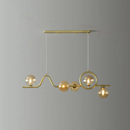 Decorbites modern curve island ceiling light with brass curved arms and amber glass globe bulbs for dining room