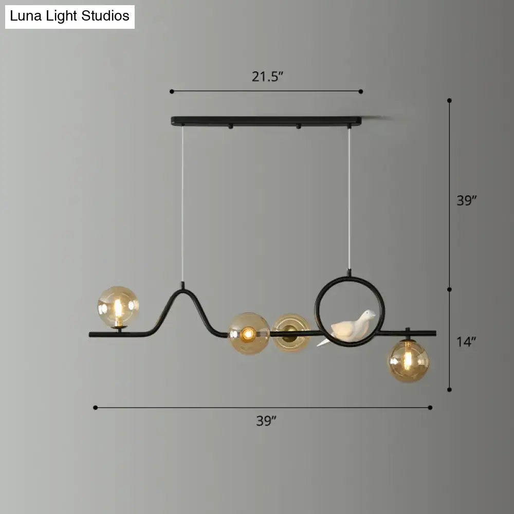 DecorBites™ modern curve island ceiling light with black metal frame, five amber glass globes, and white ceramic bird detail