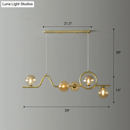 DecorBites modern curve island ceiling light with gold-toned metal arms and glass ball shades for dining room