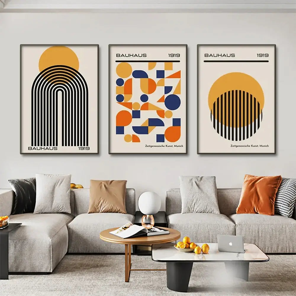 Three framed DecorBites modern geometric canvas wall art prints with black orange and blue designs on cream backgrounds