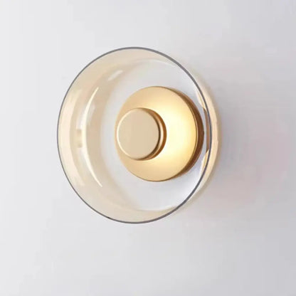 Decorbites™ modern glass led wall light features a minimalist wall light with translucent amber glass and polished brass accents
