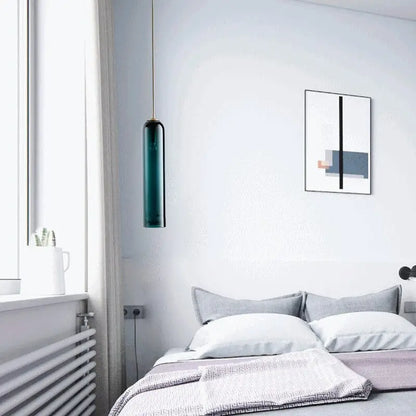 DecorBites™ modern pendant light featuring an emerald green cylindrical glass with gold-toned fixture lighting solution