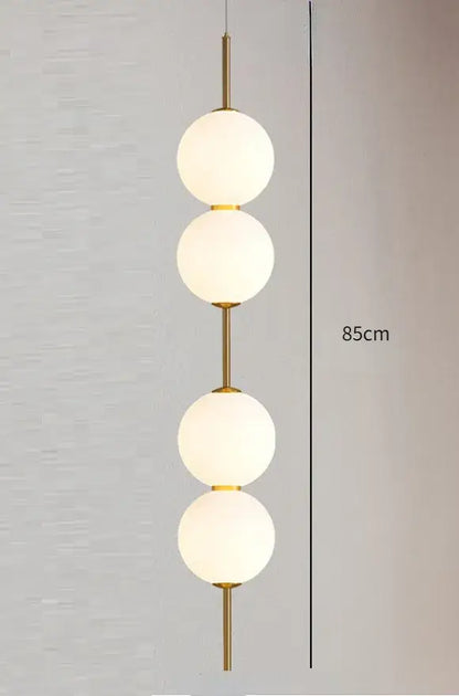 DecorBites™ modern glass pendant lighting with gold-toned frame and four frosted white spherical glass globes stacked vertically