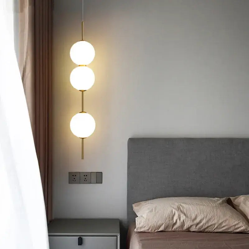 DecorBites™ modern glass pendant lighting with three frosted glass spheres and gold-toned metal rods