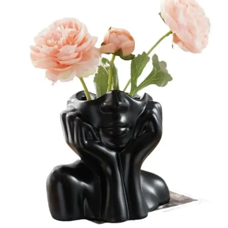 DecorBites™ black resin vase shaped like a human body holding pink peonies with body shaping design