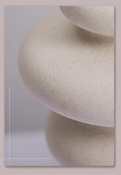 Cream-colored speckled stone balancing sculpture featured with DecorBites™ ins style ceramic spiral vase