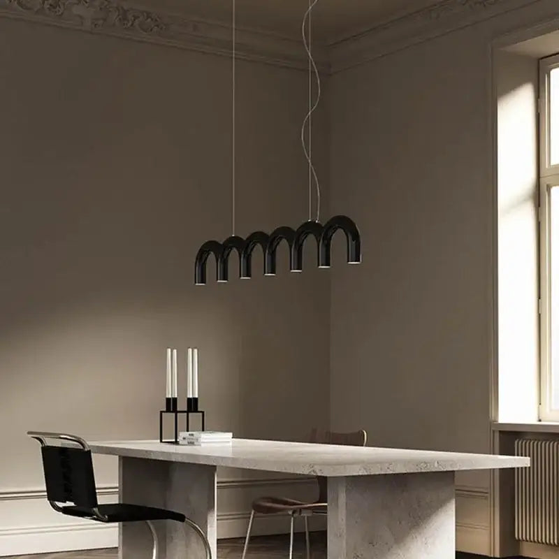 Black arch chandelier from decorbites™ modern led oblure arch chandelier with sleek design above minimalist table