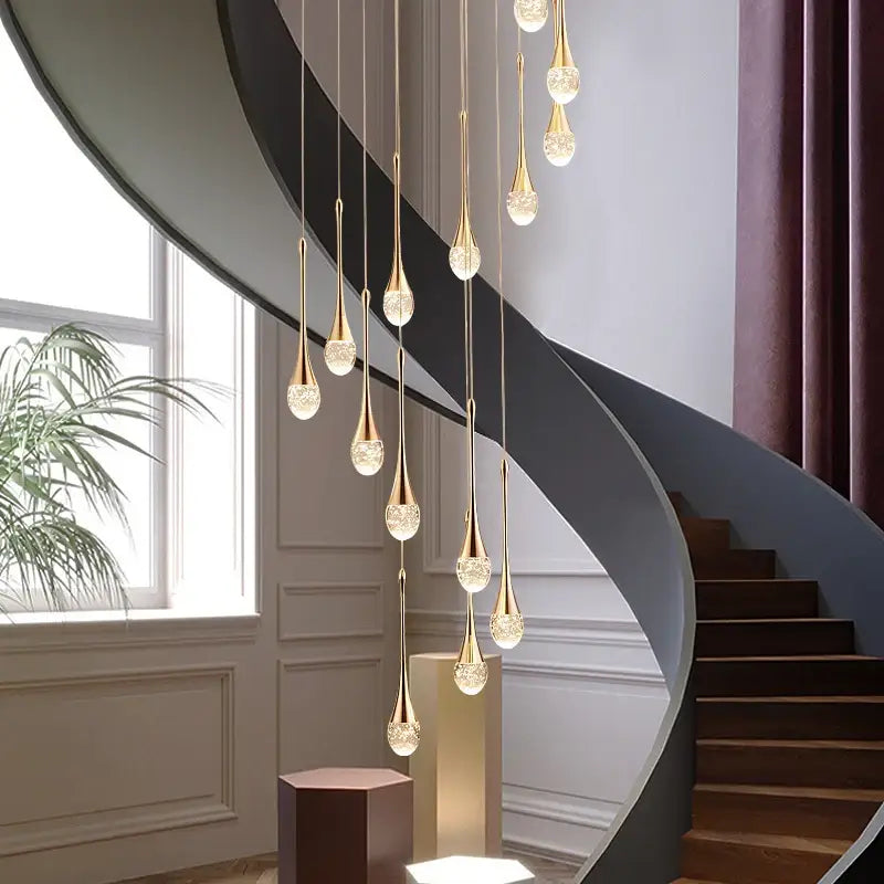 Golden teardrop-shaped led crystal chandelier with crystal-encrusted bases hanging elegantly for home decor