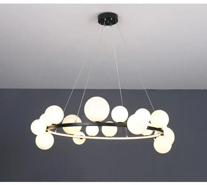 Modern black metal chandelier with multiple frosted glass globe lights and adjustable cord for versatile installation