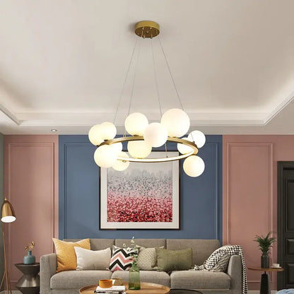 DecorBites™ modern gold-toned chandelier with frosted glass globe lights and adjustable cord in circular design