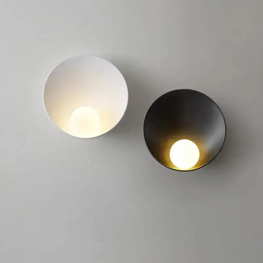 Two minimalist decorbites™ modern led wall lights in matte white and brushed black with circular recessed light sources