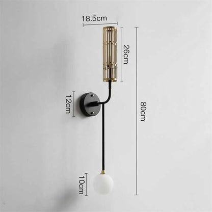 DecorBites™ modern wall sconce with black metal base, gold accents, curved arm, and frosted glass globe bulb