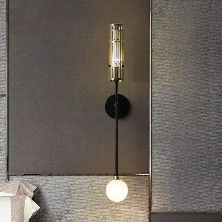 DecorBites™ modern wall sconce with gold accents featuring a brass-finished cylindrical slatted design and frosted glass bulb