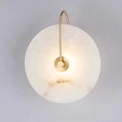 DecorBites modern marble wall lamp featuring a sleek white marble disc and slender brass arm for elegant lighting