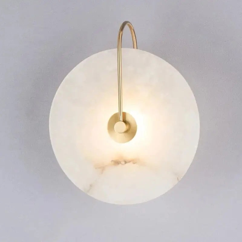 DecorBites modern marble wall lamp featuring a sleek white marble disc and slender brass arm for elegant lighting