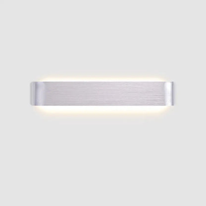 DecorBites™ modern metal wall sconce in brushed silver with sleek minimalist design and warm ambient lighting