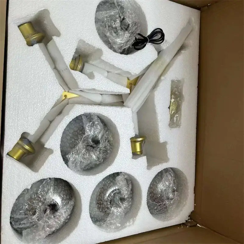 Set of five metallic spiral-shaped pendant lights with gold-toned fixtures and white arms in modern nordic glass chandeliers