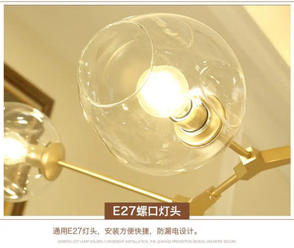 DecorBites modern nordic lustre glass chandelier with clear globe and brass stem housing illuminated e27 bulb