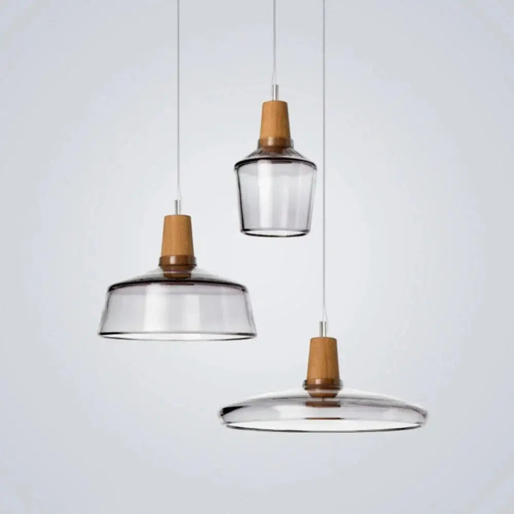Set of three DecorBites modern nordic glass light fixtures with clear glass shades and warm wooden accents