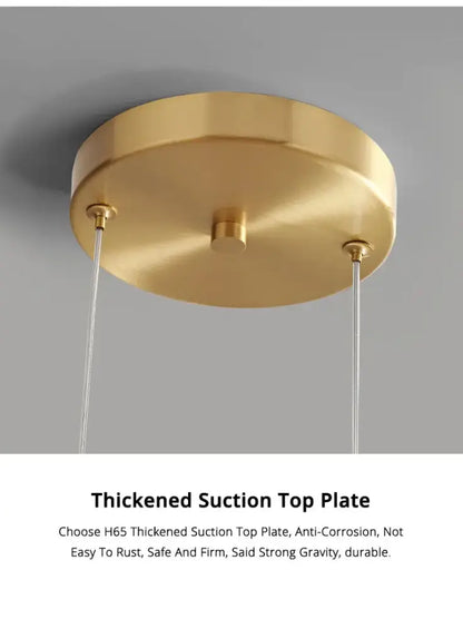 Gold-colored circular suction ceiling plate with brushed metallic finish and three mounting points for nordic glass pendant lamp