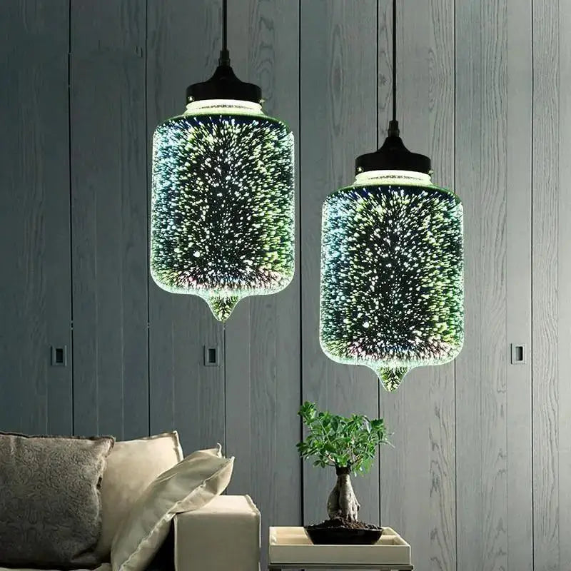 Two decorbites™ modern nordic glass pendant lights with starburst green and blue patterns in translucent bodies
