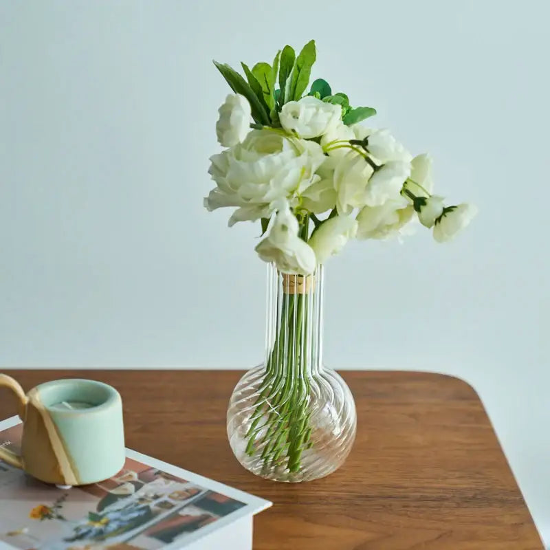 DecorBites™ modern Nordic clear glass vase with vertical ridges and white artificial flowers for home decor