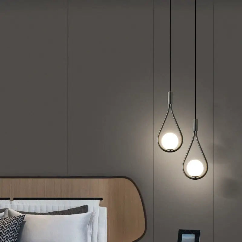 DecorBites™ modern nordic pendant light features two sleek black teardrop pendant lights with warm metallic frames