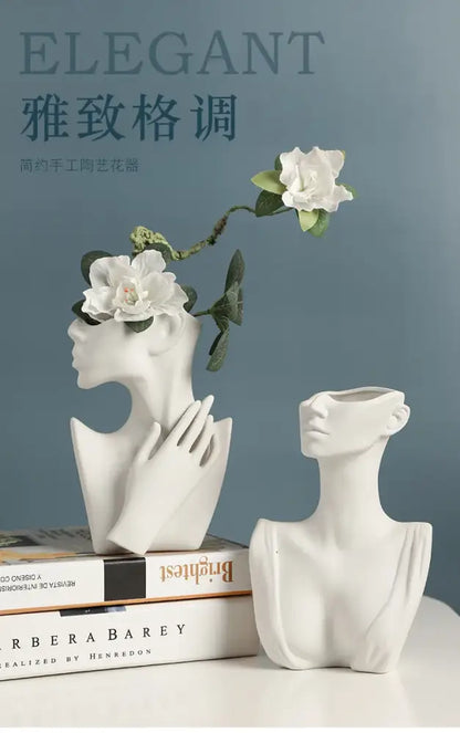 White ceramic nordic style ceramic body vase shaped like a woman bust with hand gently resting on cheek by DecorBites