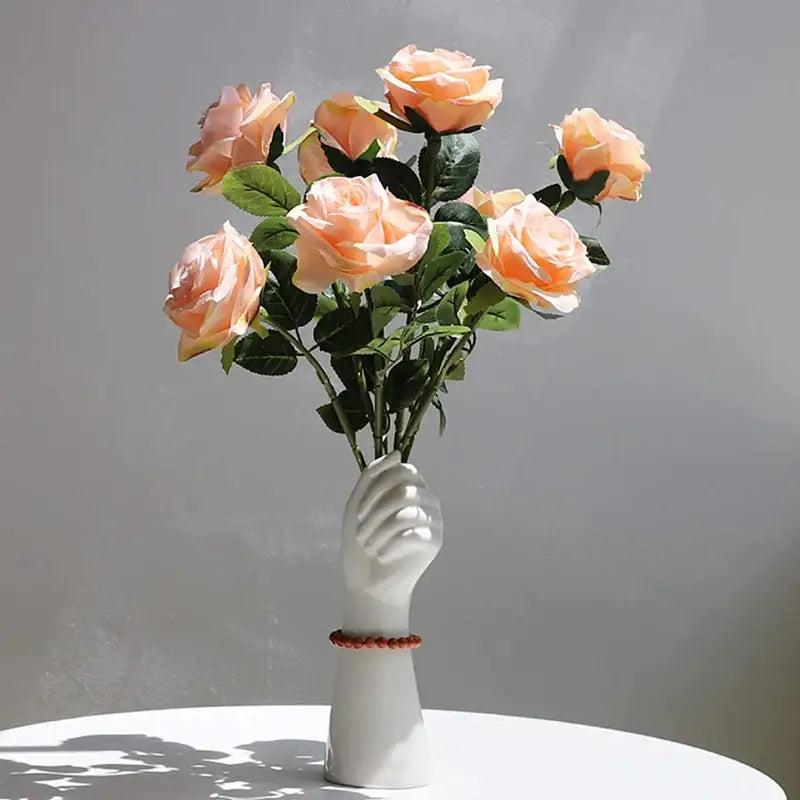 A white ceramic hand vase holding roses in modern nordic style by decorbites for elegant home decor