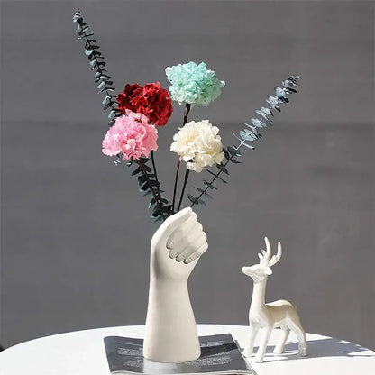 Modern nordic style white ceramic hand vase holding colorful artificial flowers by decorbites