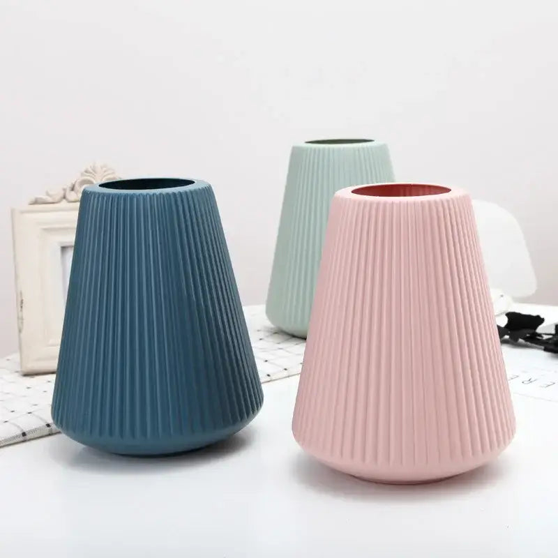 Three modern nordic ribbed plastic vases in soft blue mint green and blush pink tones for creative vase home decor
