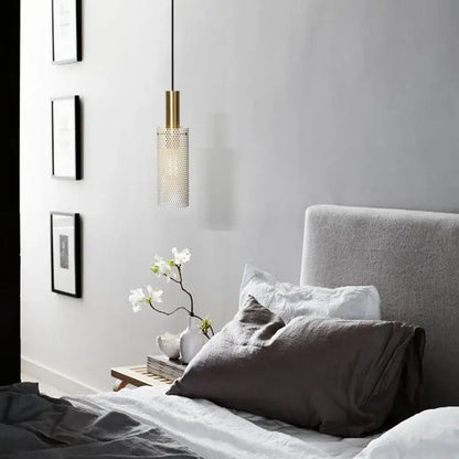 DecorBites modern pendant light with gold-toned cylindrical fixture and perforated translucent glass shade hanging from black cord