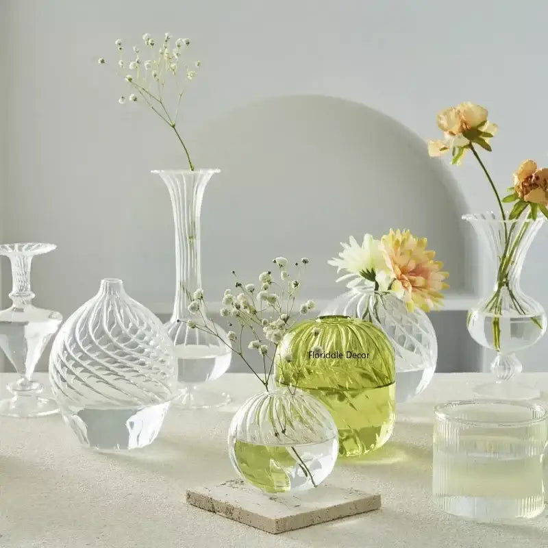 A clear intricately ribbed glass vase with rounded base and slender neck from decorbites modern transparent glass vases set