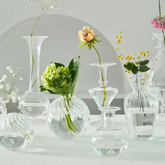 DecorBites modern transparent glass vases set with ribbed textures holding delicate flowers to decorate root spaces