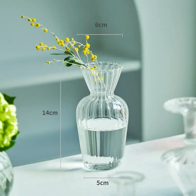 Decorbites™ modern transparent glass vase with vertical ridges and fluted rim holding yellow flowers for home decor