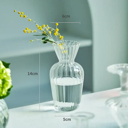 DecorBites™ modern transparent glass vase with vertical ridges and fluted rim holding yellow flowers in water