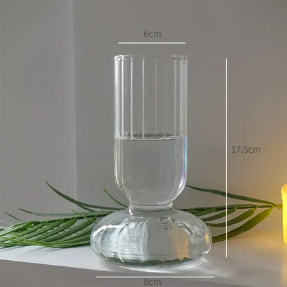 DecorBites modern transparent glass vase with vertical ridges and fluted base filled halfway with water for home decor