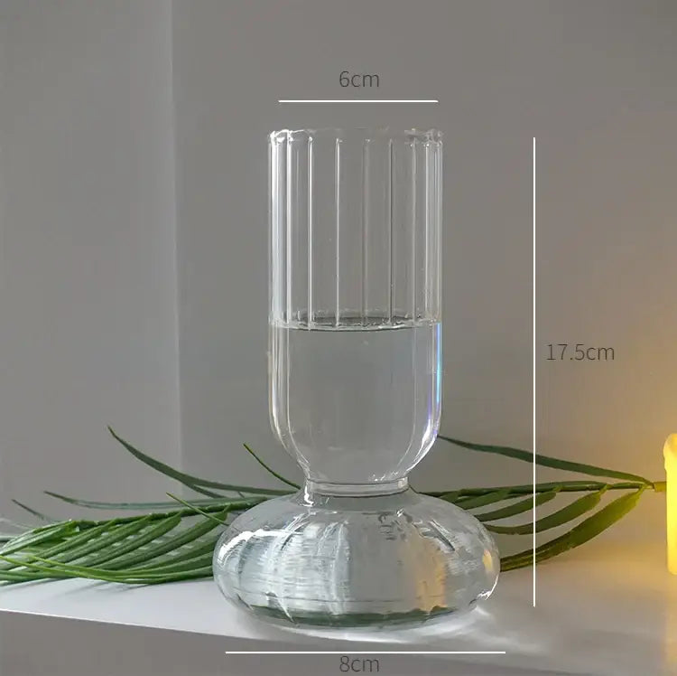 DecorBites modern transparent glass vase with vertical ridges and fluted base filled halfway with water for home decor